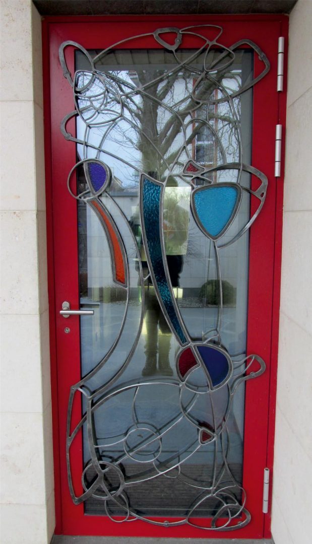 Forged metal gates, coated with hot zinc, painted, stained glass.